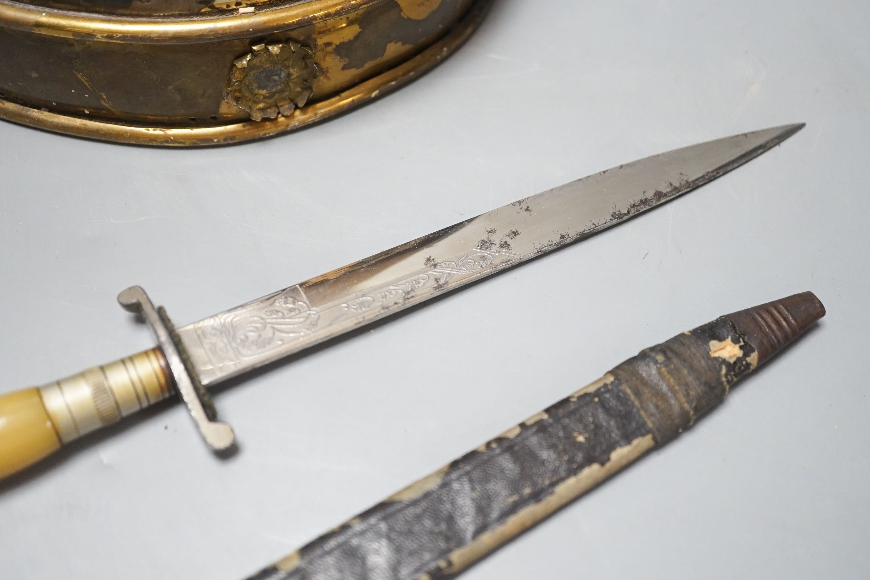 A Middle-Eastern silvered metal and brass helmet and a dagger in sheath